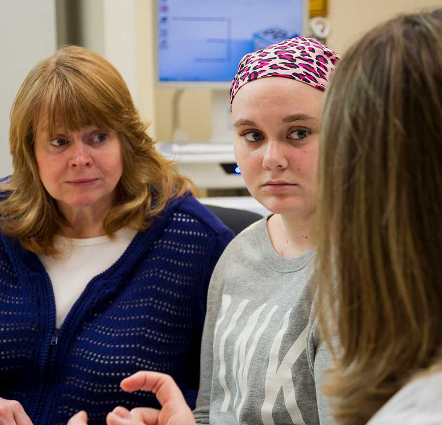 Image of young adult cancer patient speaking with clinician.