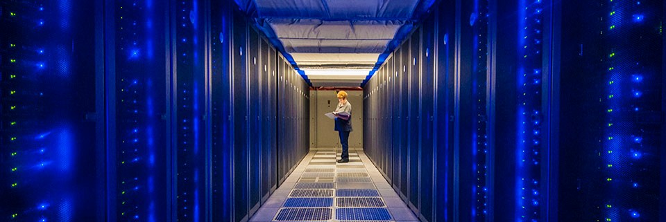 Computer scientist surveying the operations of a large-scale server room.
