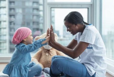 Woman and child playing game that involves clapping hands together. Both look happy and are enjoying each other's company.