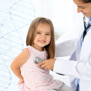 Small female child with long brown hair smiling while doctor using stethoscope to hear heart beat