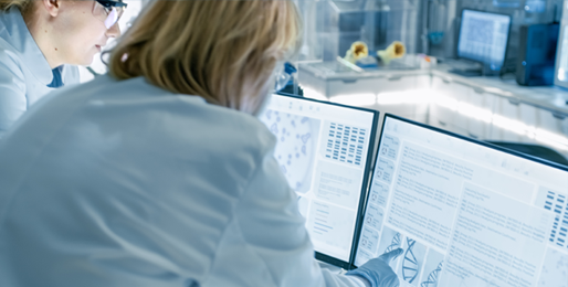 Image of researcher looking at case reports, genomic, and phenotypical data with a colleague