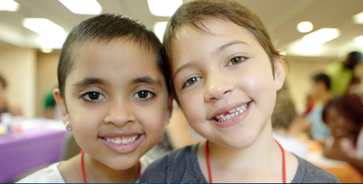 Image of two children smiling broadly