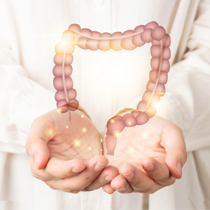 An illustrated colon is shown, cradled in the outstretched hands of a doctor wearing a white lab coat. 