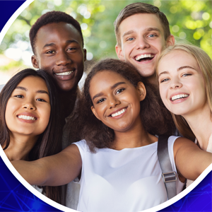 Image of two teenage boys and three teenage girls standing together in a circular shape, smiling.