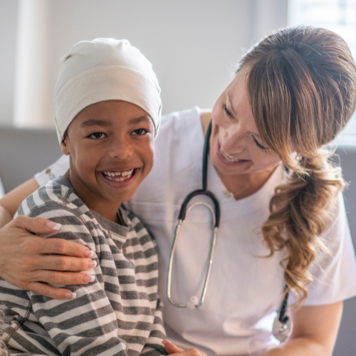 Nurse and childhood cancer patient smiling