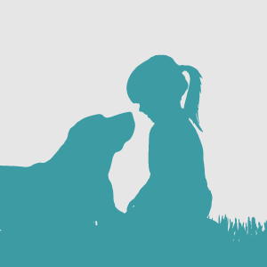 Silhouette of a dog and little girl sitting in the grass and facing one another.    